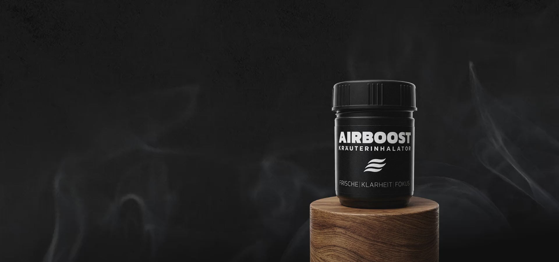 AIRBOOST Kräuterinhalator für mehr Frische, Klarheit und Fokus auf einem Holztisch im Hintergrund mit leichtem Rauch als Aromavisualisierung.